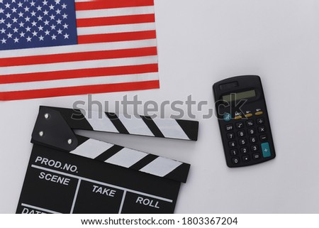 Movie clapper board and calculator, USA flag on white background. Cinema fees. Filmmaking, Movie production. Top view
