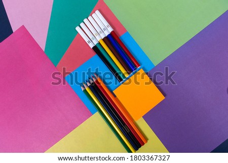 the pencils and flares on a multi-colored background