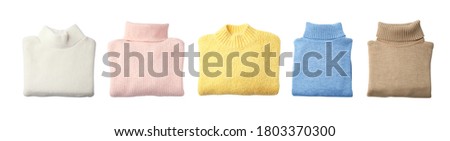 Set of stylish sweaters on white background, top view. Banner design