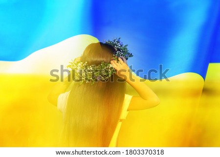 Double exposure of cute little girl wearing flower wreath in field and Ukrainian flag 