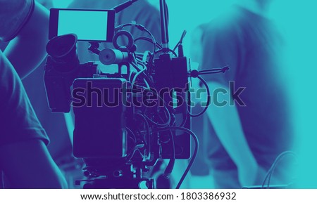 Behind the scenes of video recording or filming online movie by 8K high definition digital camera and professional monitor. And flare lighting set up with film crew team in the studio production.