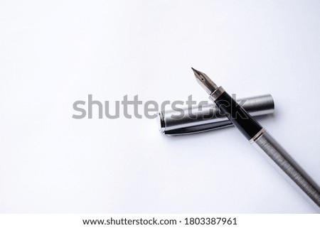 Elegant fountain ink pen isolated on white paper background