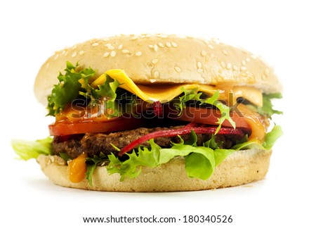 Delicious cheeseburger with beef, cheese, fresh lettuce, onion and tomato on a fresh bun with sesame seed 