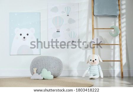 Baby room interior with toys and cute posters on wall
