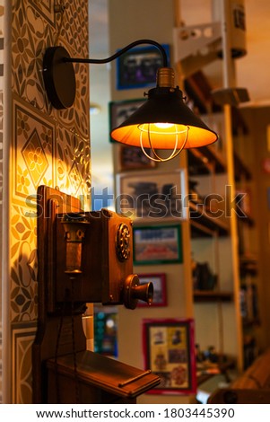 Old retro rotary dial telephone in a retro-themed cafe.