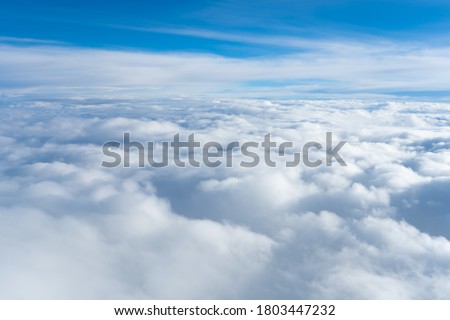 Fluffy clouds top view of the airplane. Heavenly landscape. Royalty-Free Stock Photo #1803447232