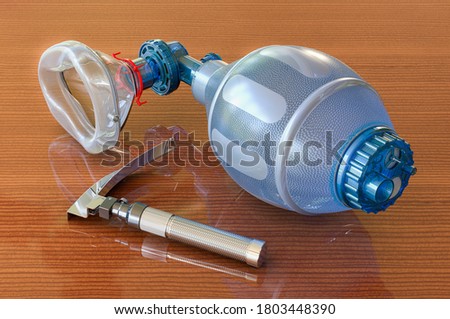 Laryngoscope and Ambu Bag for ventilation resuscitation on wooden table, 3D rendering Royalty-Free Stock Photo #1803448390