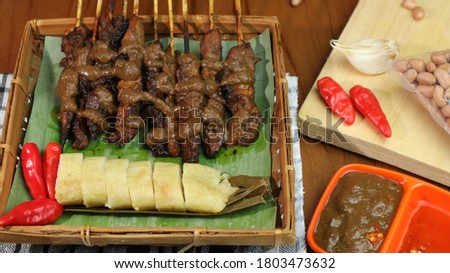 Chicken satay, a food that many Madurese sell with lontong and peanut sauce as a complement to the dish. this picture perfect for your commercial purposes
