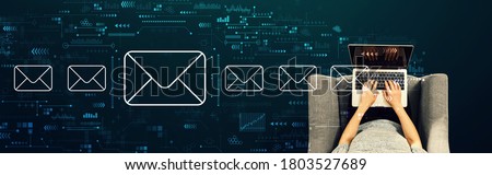 Email concept with person using a laptop in a chair Royalty-Free Stock Photo #1803527689