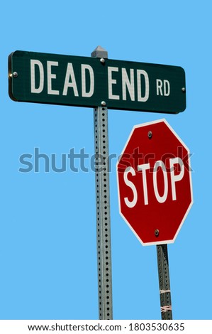 Nebraska. Juxtaposition of a dead end road sign and a stop sign in a humorous position. 