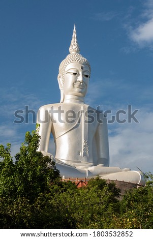 Meditating Buddha statue painted stucco white Located on the highest mountain in Mukdahan province in Thailand