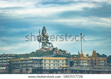 murdeshwar shiva statue morning view from low angle with sea waves image is taken at murudeshwar karnataka india at early morning. it is the house of one of the tallest rajagopuram in the world. Royalty-Free Stock Photo #1803557728