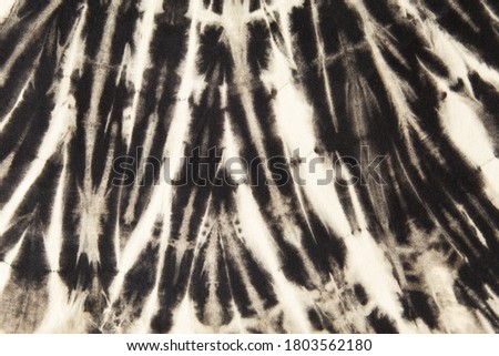 black and white abstract spiral tie dye pattern.