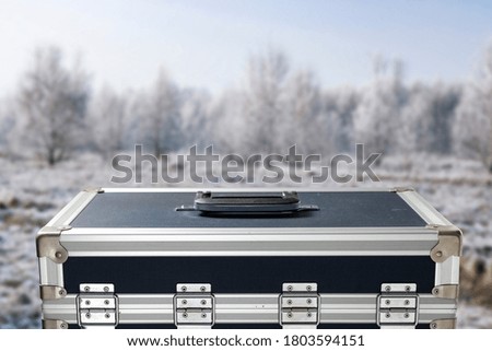 The photographer's suitcase on a winter background with a free space for an advertising product