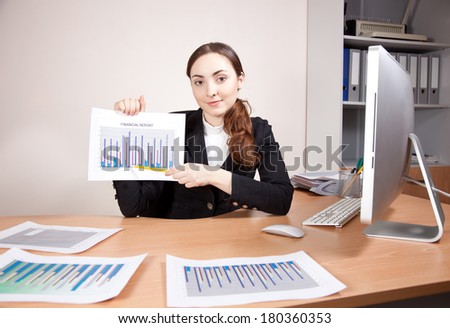 Businesswoman with financial reports at the office