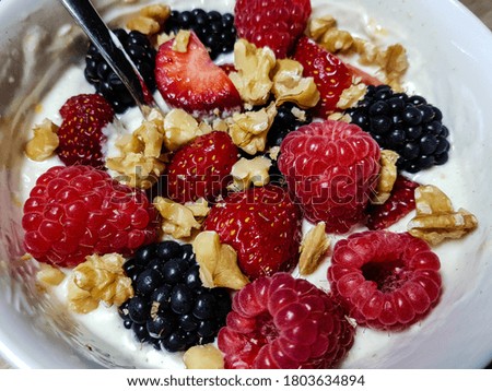 Breakfast yoghurt with blackberries strawberries raspberries and walnut