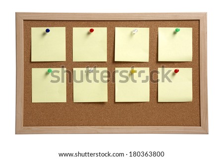 blank yellow notes pinned to cork board on white background