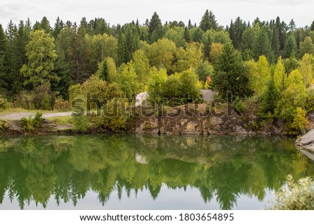 Stunning photo of fall foliage reflected on a lake with a glass like mirror water surface