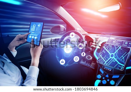 Driverless car interior with futuristic dashboard for autonomous control system . Inside view of cockpit HUD technology using AI artificial intelligence sensor to drive car without people driver . Royalty-Free Stock Photo #1803694846