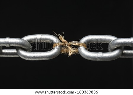 Metal chain with link missing replaced by rope on black background Royalty-Free Stock Photo #180369836