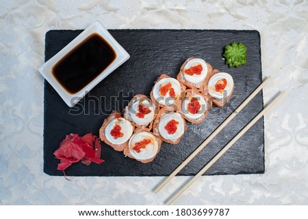 Delicious, juicy and appetizing Philadelphia rolls deluxe with red caviar