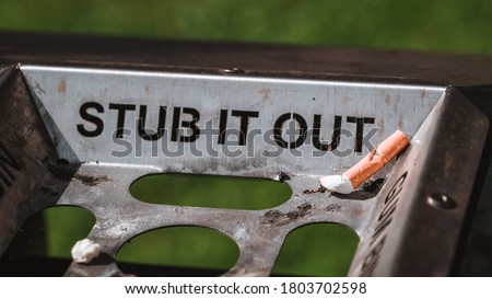 	
Stub it out - close up of a cigarette stub on a waste bin