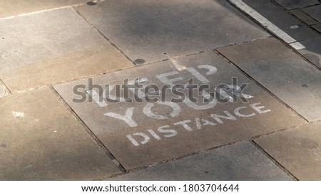 Keep your distance sign painted onto a pavement in Oxford as part of social distancing measures