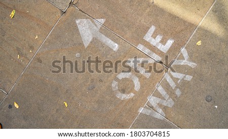One way sign painted on the pavement in Oxford as part of social distancing measures