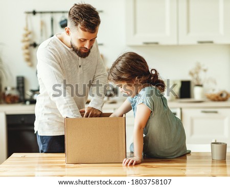 Young man and little daughter unpacking carton box with delivered order while spending time together in home kitchen
 Royalty-Free Stock Photo #1803758107