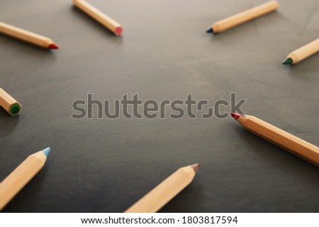 Background image of pencils over chalkboard