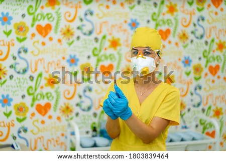Doctor or nurse hand in blue gloves holding syringe with vaccine for a baby or adult. Medicine and drug concept.