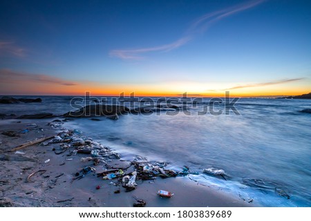 A beautiful view after the sunset and the debris from the sea waves hitting the shore. Long exposure picture style.