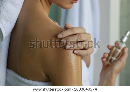 Woman applying body oil to moisturize her skin after shower, beauty skin care concept	 Royalty-Free Stock Photo #1803840574
