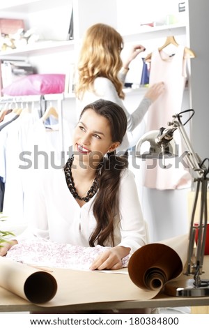 Close-up of young fashion designer working in her studio. 