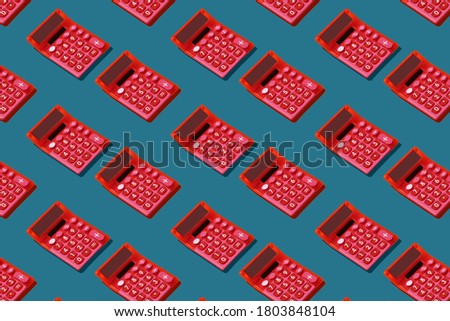 Retro style pink calculators pattern on blue background