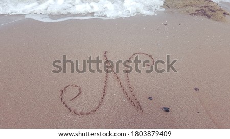 N Alphabet letters writing on the sand beach
.