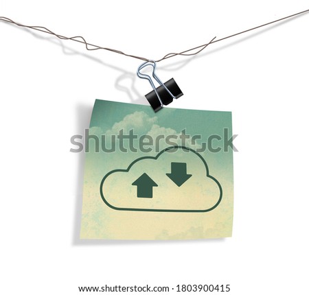 A cloud icon on a piece of grunge covered paper hangs on a wire from a paper clamp in this illustraton about internet cloud services.