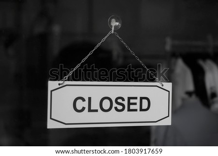 A sign hanging off clothing store door, Close sign blur background, Label word close.
