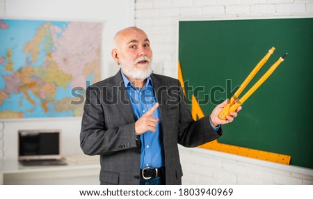 senior man teacher use compass tool. bearded tutor man draw with compass on blackboard. back to school. 