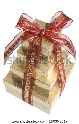 Gold Christmas presents with red bow on white background 