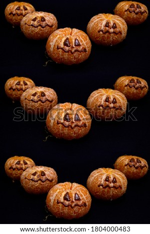 pattern with face on tangerine or mandarin orange like a halloween pumpkin head jack o lantern.