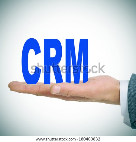 a man holding the acronym CRM for Customer Relationship Management