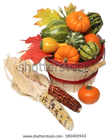basket of vegetables and corncobs on white 