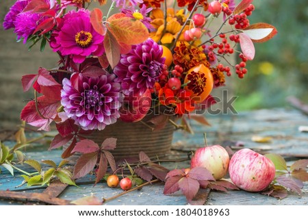 Autumn flowers closeup background, fall flowers bouquet, florist composition with dahlia and apples	