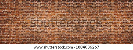 Vintage exposed brown and red old brick wall. Brickwork textured background and long brown banner.