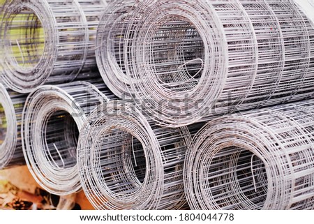 Selective focus of iron wire mesh rolls for construction site. Building construction materials and concrete tools background and texture.