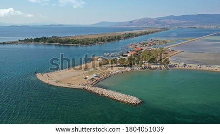 Aerial drone photo of organised sandy beach in area Tourlida of Kleisova lagoon featuring seaside traditional settlement, Mesolongi, Aitoloakarnania, Greece