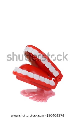 Wind up chattering teeth toy cutout, isolated on white background Royalty-Free Stock Photo #180406376