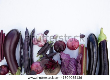 Collection of fresh purple vegetables on a white background with space for text. Banner, poster, advertisement. Royalty-Free Stock Photo #1804065136