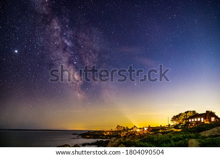 Milky way galaxy above the rocky coastline in New England. 